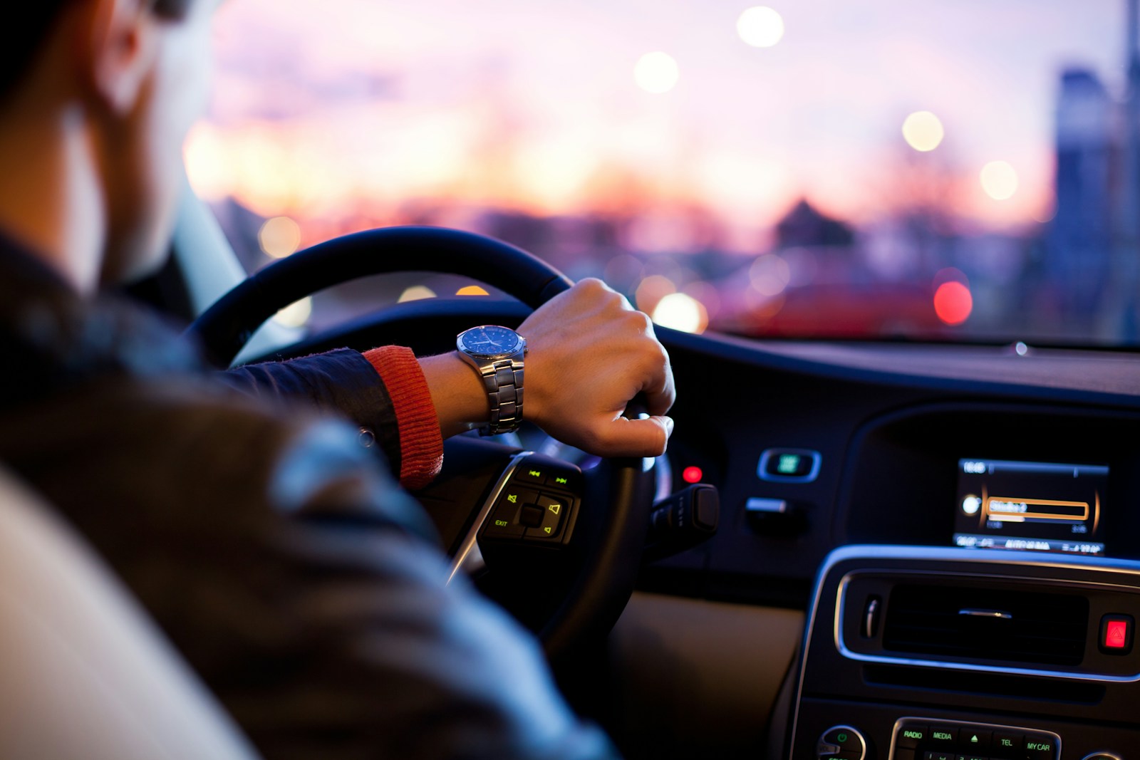 man driving a car wearing wrist watch auto